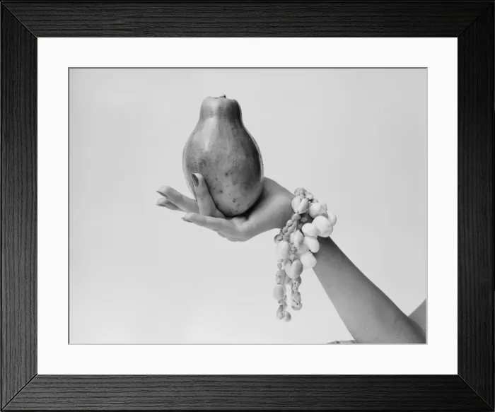 Framed Print : Woman holding papaya, close-up