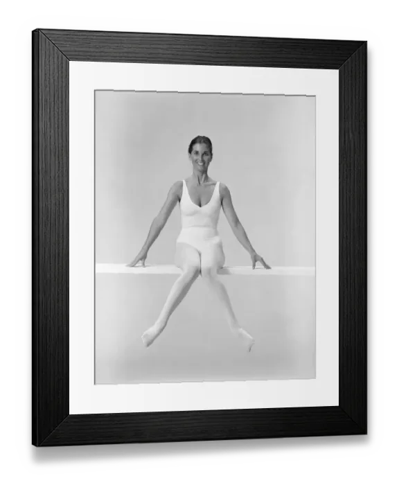 Framed Print : Woman sitting on balance beam, smiling Framed Print : Woman sitting on balance beam, smiling