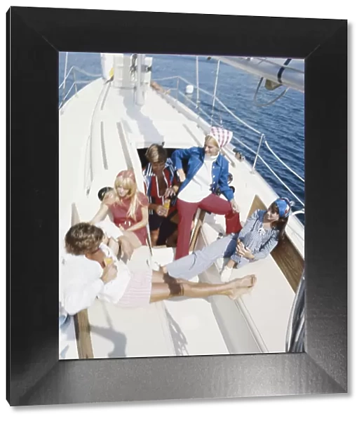 Group of friends in sailing boat