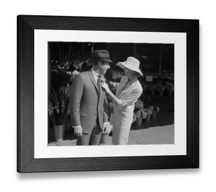 Framed Print : Woman putting flower on mans suit Framed Print : Woman putting flower on mans suit