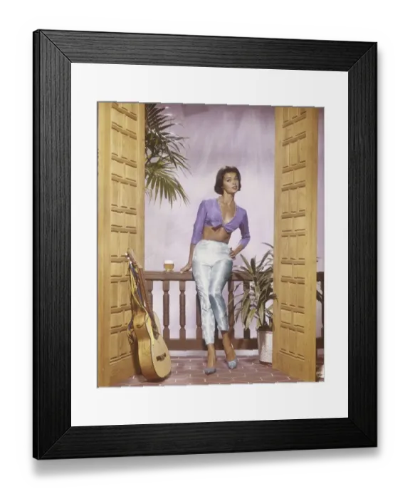 Framed Print : Young woman standing in balcony with beer glass, portrait Framed Print : Young woman standing in balcony with beer glass, portrait