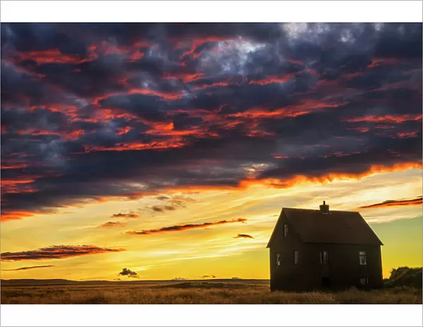 Abandoned house in rural Iceland with a brilliant sunset
