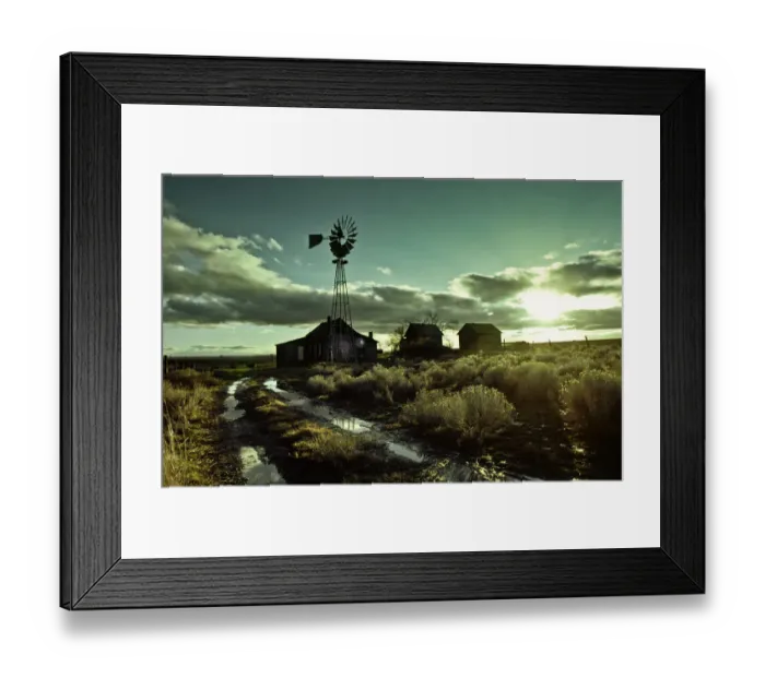 Framed Print : Abandoned homestead with windmill at sunrise
