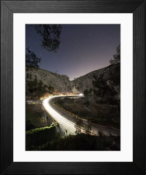 Framed Print : Lights of vehicles circulating along a road with curves during the night
