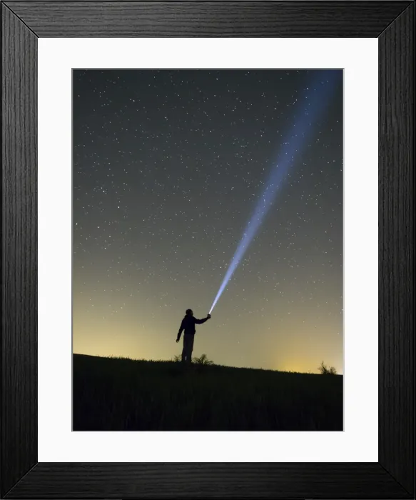 Framed Print : Person lighting the sky with a flashlight Framed Print : Person lighting the sky with a flashlight