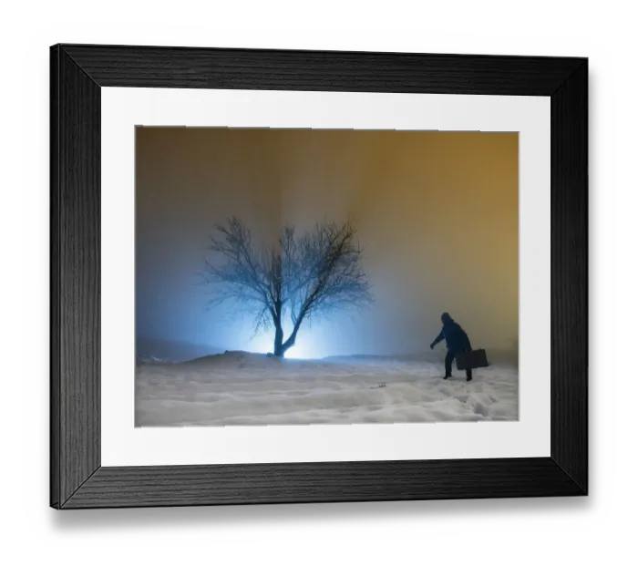 Framed Print : Silhouette of a person walking with a suitcase, for a covered way of snow and fog during the night