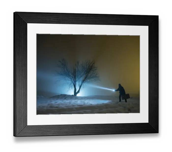Framed Print : Silhouette of a person walking with a suitcase and a lantern, for a covered way of snow and fog during the night Framed Print : Silhouette of a person walking with a suitcase and a lantern, for a covered way of snow and fog during the night