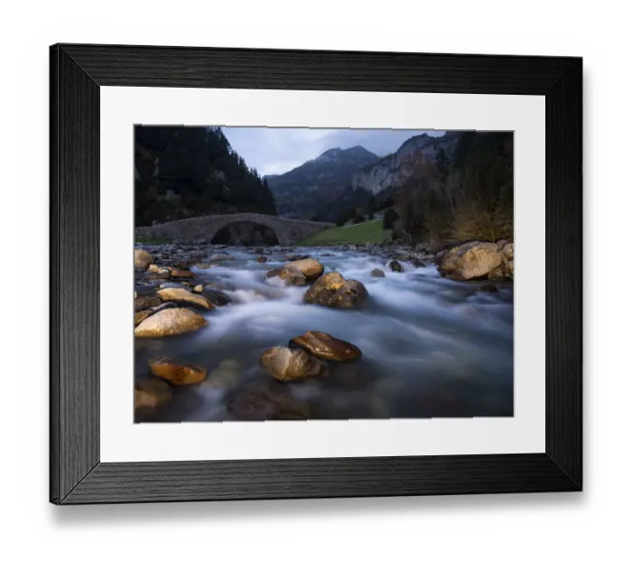 Framed Print : Rio of high mountain crossing a bridge in a valley