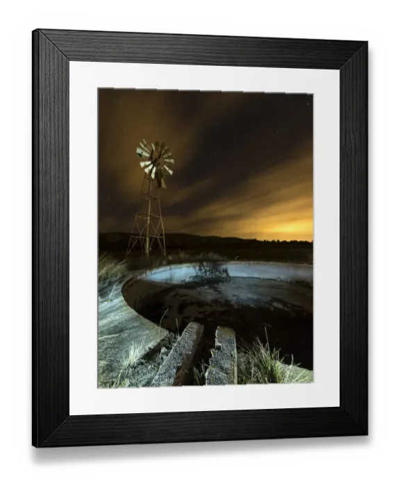 Framed Print : A metal tower windmill at night