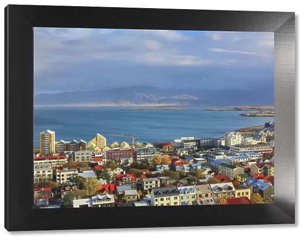 Aerial view over downtown Reykjavik with ocean and mountain at back, Iceland