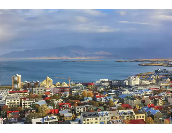 Aerial view over downtown Reykjavik with ocean and mountain at back, Iceland