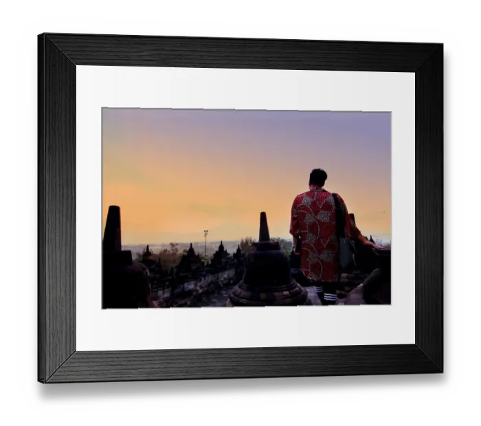Framed Print : Man in dress overlooking mountains at Borobudur Framed Print : Man in dress overlooking mountains at Borobudur
