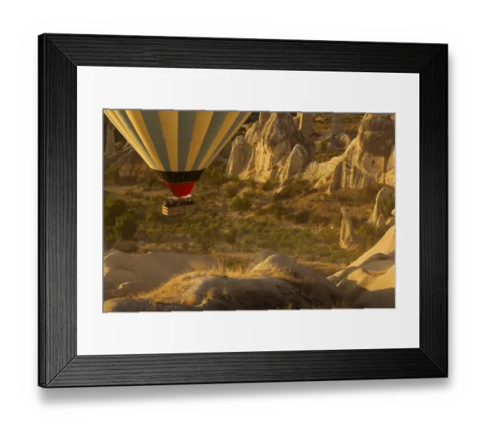 Framed Print : Hot air balloon flying over rock landscape at Cappadocia Turkey Framed Print : Hot air balloon flying over rock landscape at Cappadocia Turkey