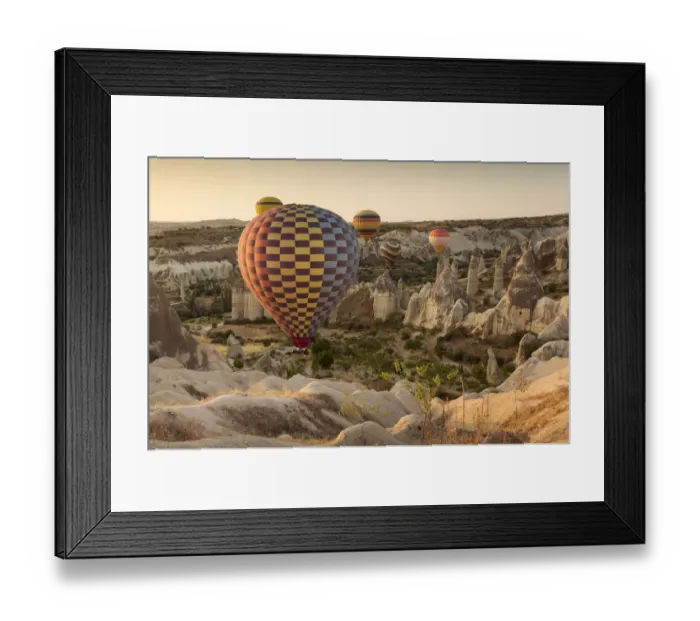 Framed Print : Hot air balloon flying over rock landscape at Cappadocia Turkey Framed Print : Hot air balloon flying over rock landscape at Cappadocia Turkey