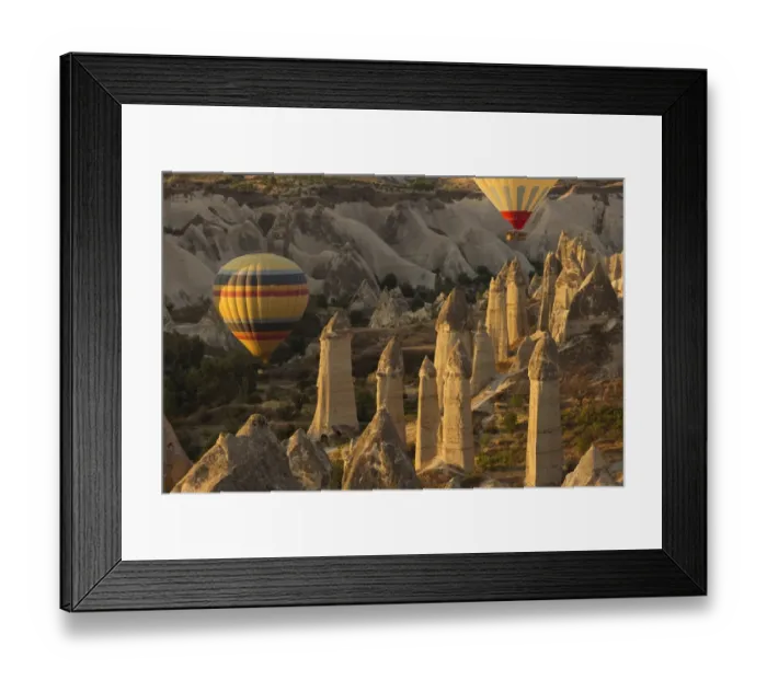 Framed Print : Hot air balloon flying over rock landscape at Cappadocia Turkey Framed Print : Hot air balloon flying over rock landscape at Cappadocia Turkey