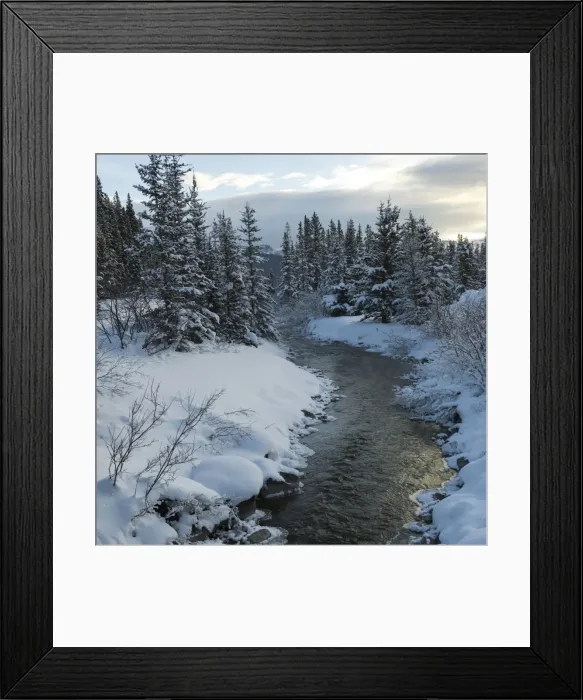 Framed Print : A river flowing through a snow covered landscape Framed Print : A river flowing through a snow covered landscape