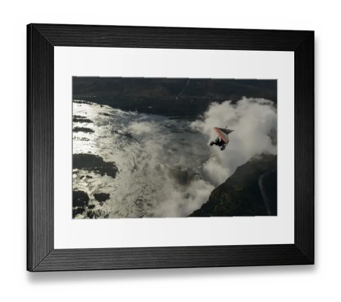 Framed Print : Aerial view of a micorlight (ultralight) flying over the Zambezi River and Victoria Falls. Livingstone. Zambia Framed Print : Aerial view of a micorlight (ultralight) flying over the Zambezi River and Victoria Falls. Livingstone. Zambia