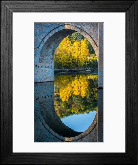 Framed Print : An archway of the Valentre Bridge in Cahors, France with the Lot River flowing underneath