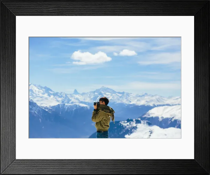 Framed Print : A Man taking a photo with the background of Alps Framed Print : A Man taking a photo with the background of Alps
