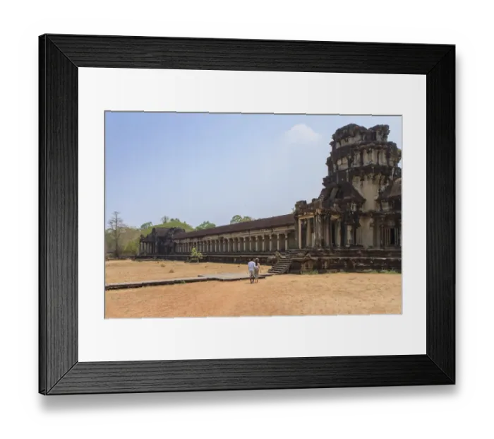 Framed Print : A Khmer couple from distance entering Angkor Wat Temple