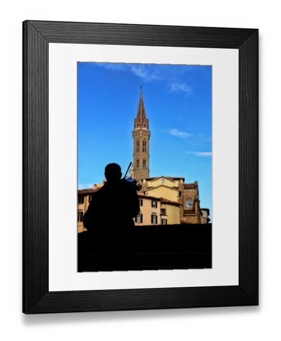 Framed Print : Street musician plays a violin in front of Badia Fiorentina bell-tower in Florence, Italy