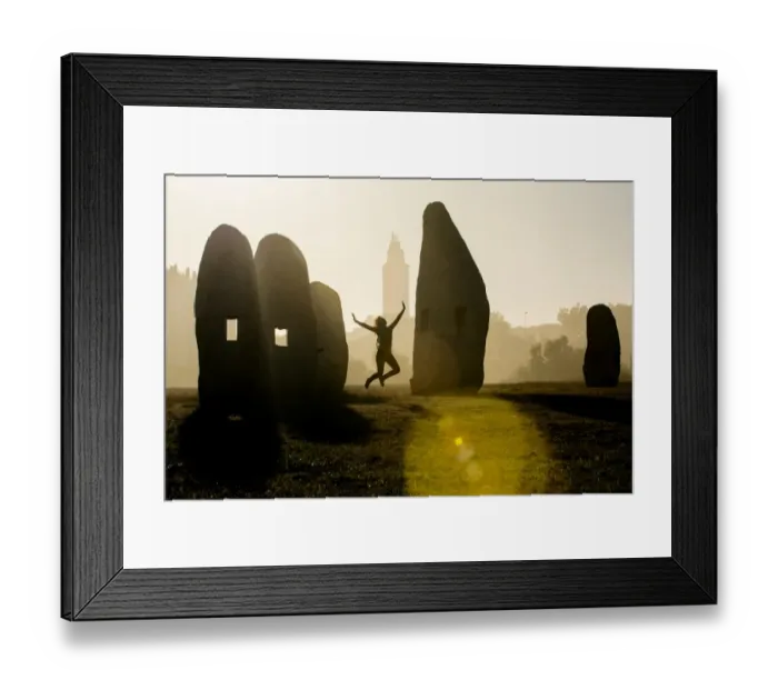 Framed Print : Young woman jumping in midair outdoors, in front of Hercules Tower, A Coruna, Spain Framed Print : Young woman jumping in midair outdoors, in front of Hercules Tower, A Coruna, Spain
