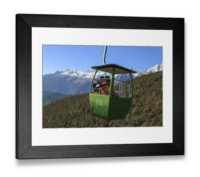 Framed Print : Cable Car on foreground with some tourists inside and Jade Dragon Snow Mountain on foreground Framed Print : Cable Car on foreground with some tourists inside and Jade Dragon Snow Mountain on foreground