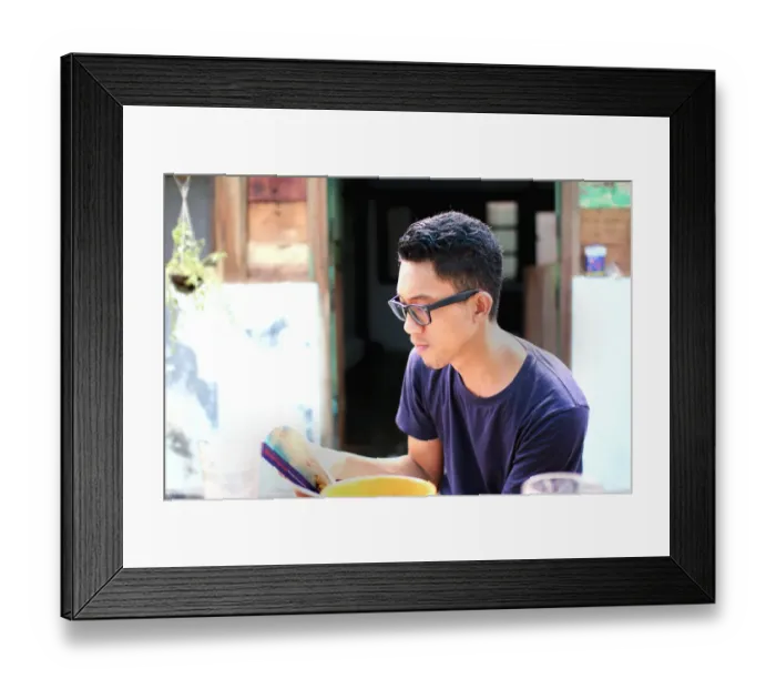 Framed Print : Reading a book while having breakfast Framed Print : Reading a book while having breakfast