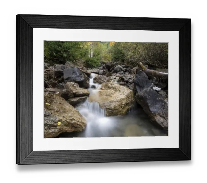 Framed Print : Stream of high mountain between big rocks crosses a forest in autumn Framed Print : Stream of high mountain between big rocks crosses a forest in autumn