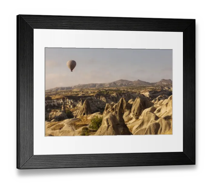 Framed Print : Hot air balloon flying over rock landscape at Cappadocia Turkey Framed Print : Hot air balloon flying over rock landscape at Cappadocia Turkey