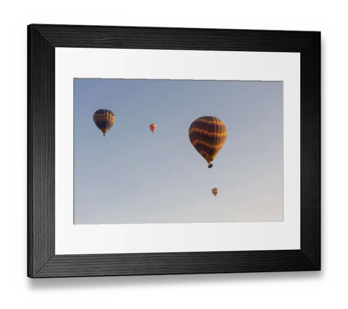 Framed Print : Hot air balloon flying over rock landscape at Cappadocia Turkey