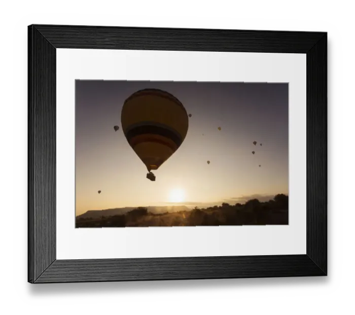 Framed Print : Hot air balloon flying over rock landscape at Cappadocia Turkey Framed Print : Hot air balloon flying over rock landscape at Cappadocia Turkey