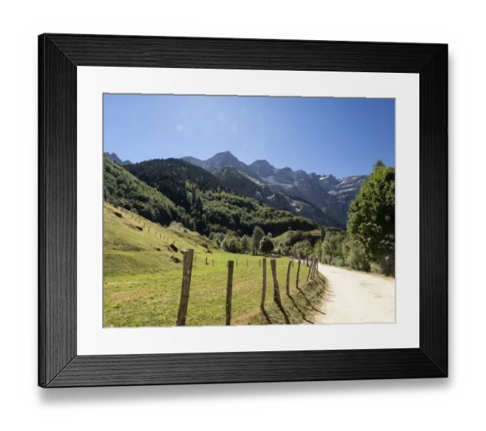 Framed Print : Mountain road that runs through the center of a valley to the circus of Gavarnie. Hautes Pyrenees. France. World Heritage Site by UNESCO Framed Print : Mountain road that runs through the center of a valley to the circus of Gavarnie. Hautes Pyrenees. France. World Heritage Site by UNESCO