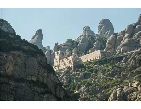 The jagged mountains in Catalonia with Cable Car (Aeri de Montserrat), Spain, showing the Benedictine Abbey at Montserrat, Santa Maria de Montserrat, near Barcelona