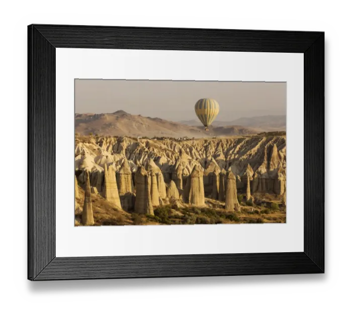 Framed Print : Hot air balloon flying over rock landscape at Cappadocia Turkey Framed Print : Hot air balloon flying over rock landscape at Cappadocia Turkey