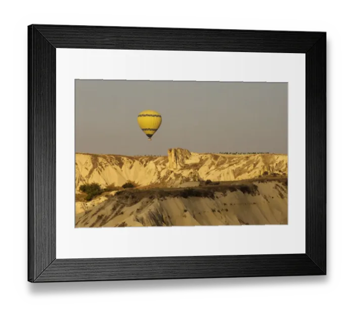Framed Print : Hot air balloon flying over rock landscape at Cappadocia Turkey Framed Print : Hot air balloon flying over rock landscape at Cappadocia Turkey