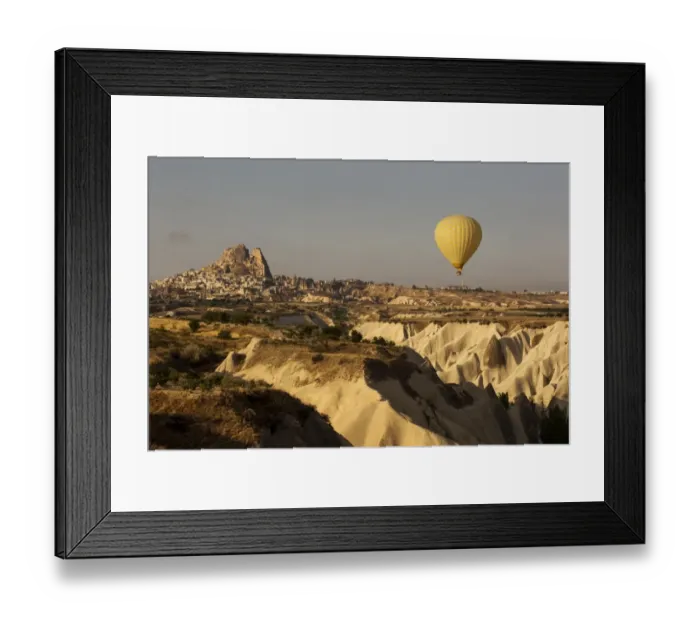 Framed Print : Hot air balloon flying over rock landscape at Cappadocia Turkey Framed Print : Hot air balloon flying over rock landscape at Cappadocia Turkey