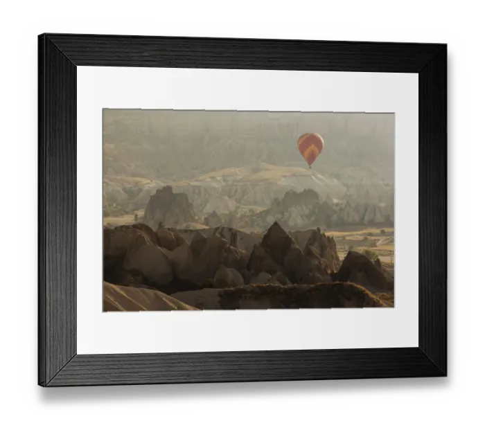 Framed Print : Hot air balloon flying over rock landscape at Cappadocia Turkey Framed Print : Hot air balloon flying over rock landscape at Cappadocia Turkey