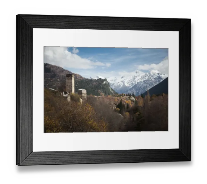 Framed Print : Typical Svanetian Tower and the High Caucasus mountains in Mestia, Svaneti, Georgia