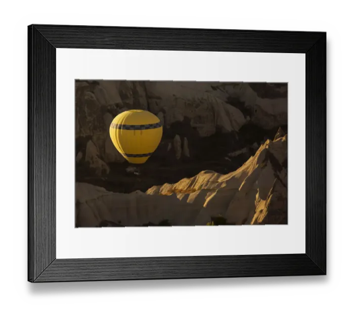 Framed Print : Hot air balloon flying over rock landscape at Cappadocia Turkey Framed Print : Hot air balloon flying over rock landscape at Cappadocia Turkey