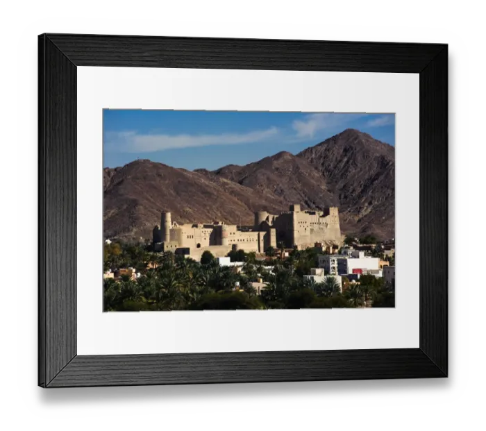 Framed Print : A view of Bahla Fort with the Hajar Mountains in the background. Northern Oman Framed Print : A view of Bahla Fort with the Hajar Mountains in the background. Northern Oman
