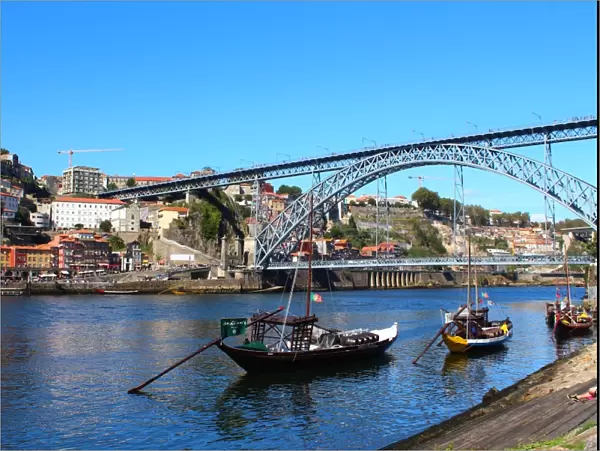 Rabelo boats and Dom Luis I bridge in Douro river, Porto