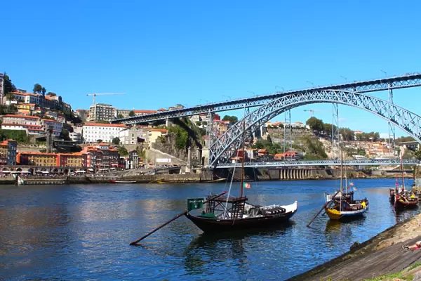 Rabelo boats and Dom Luis I bridge in Douro river, Porto