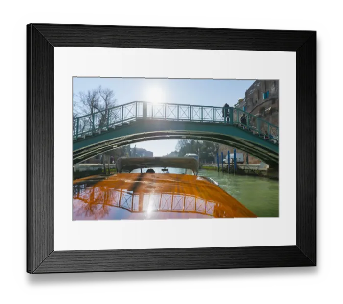 Framed Print : Taxi boat on Grand Canal and old bridge reflected on the boat roof in Venice, Italy Framed Print : Taxi boat on Grand Canal and old bridge reflected on the boat roof in Venice, Italy