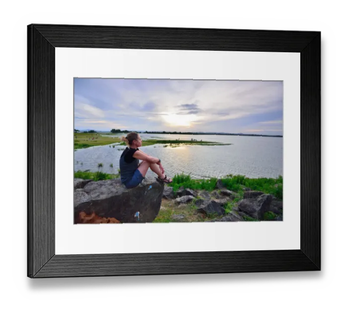 Framed Print : Woman enjoys sunset over a lake Framed Print : Woman enjoys sunset over a lake