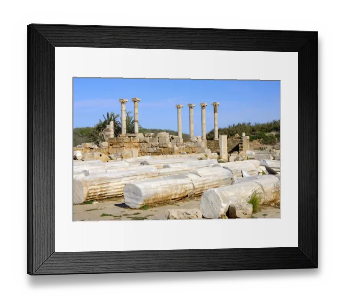 Framed Print : Lying and standing ancient columns with ionic capital, Ruins of the Roman City Leptis Magna, Libya Framed Print : Lying and standing ancient columns with ionic capital, Ruins of the Roman City Leptis Magna, Libya