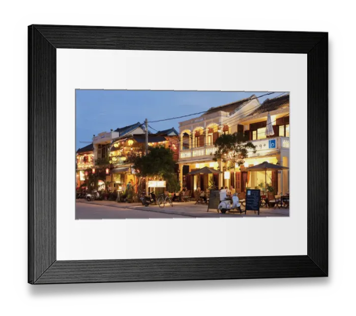 Framed Print : retaurants illuminated at dusk