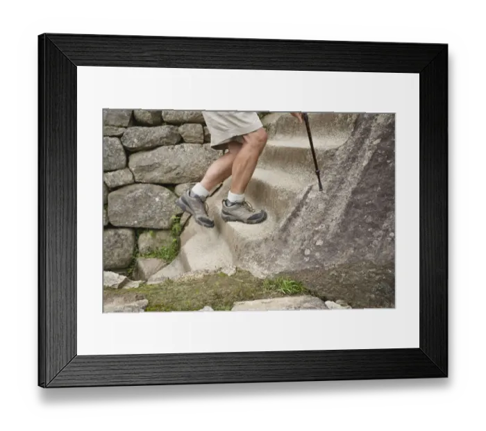 Framed Print : Peru, Machu Picchu, man climbing stone steps, low section Framed Print : Peru, Machu Picchu, man climbing stone steps, low section