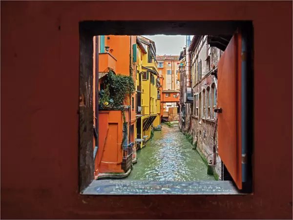 View to the canal through square window, Bologna, Emilia-Romagna, Italy