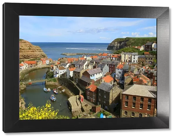 Looking seawards over cottage rooftops of the fishing village of Staithes, North Yorkshire, England